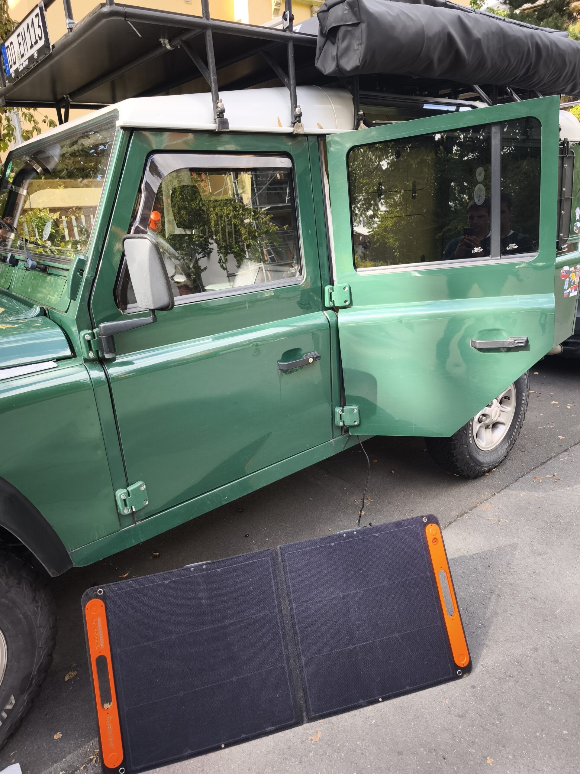 100W Solar panel in front of the Defender